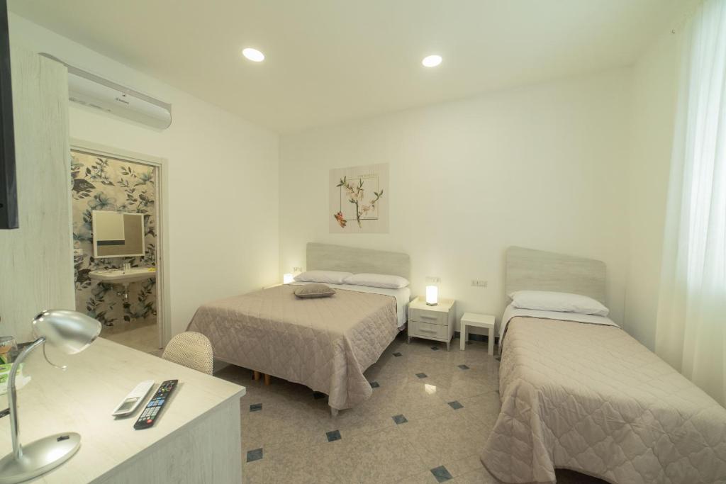 Postel nebo postele na pokoji v ubytování B&B MANDORLO BIANCO