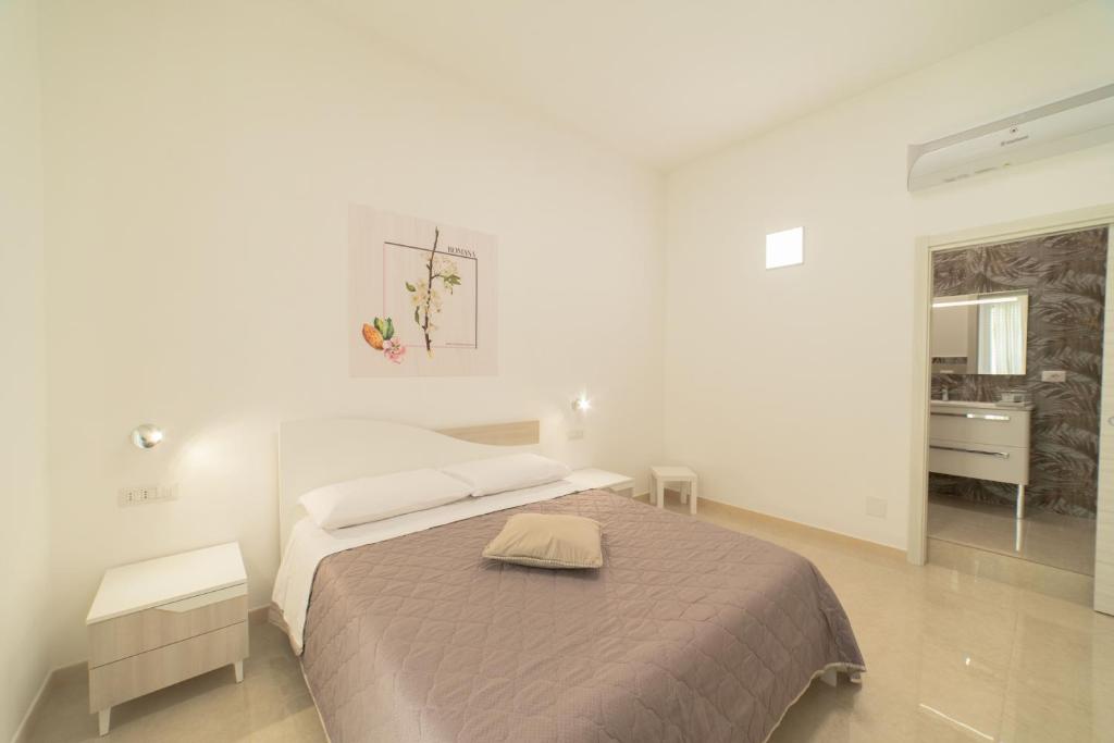 Postel nebo postele na pokoji v ubytování B&B MANDORLO BIANCO