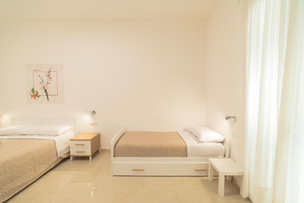 Postel nebo postele na pokoji v ubytování B&B MANDORLO BIANCO