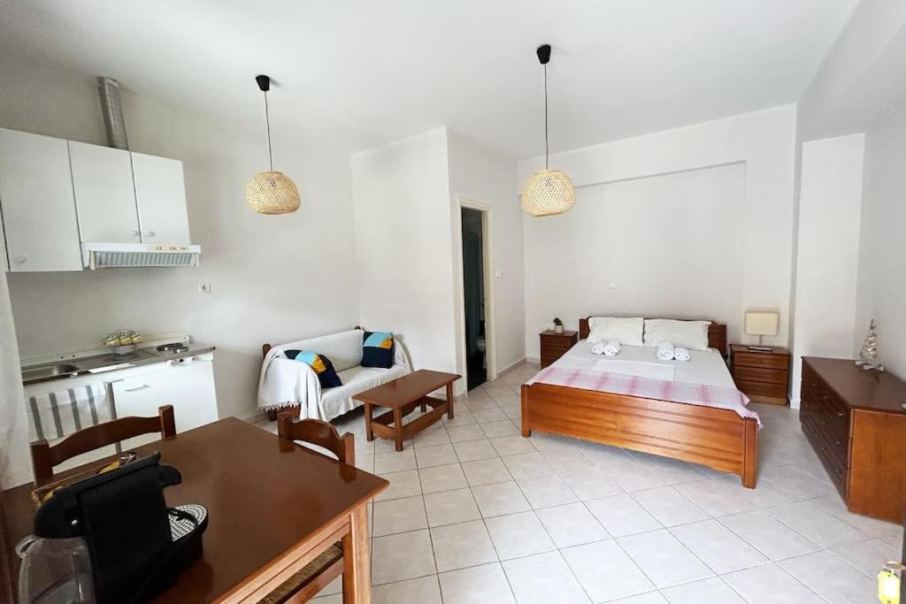 a large room with a bed and a kitchen at Cozy studio in Skala, Agistri in Skala