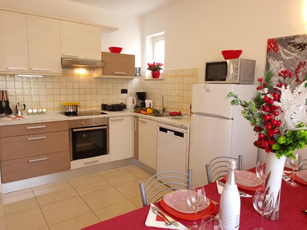 a kitchen with a table and a white refrigerator at Apartments Medulin - Orijeta in Medulin