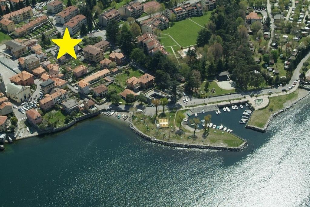 an island in the water with a yellow star on it at Il girasole in Dervio