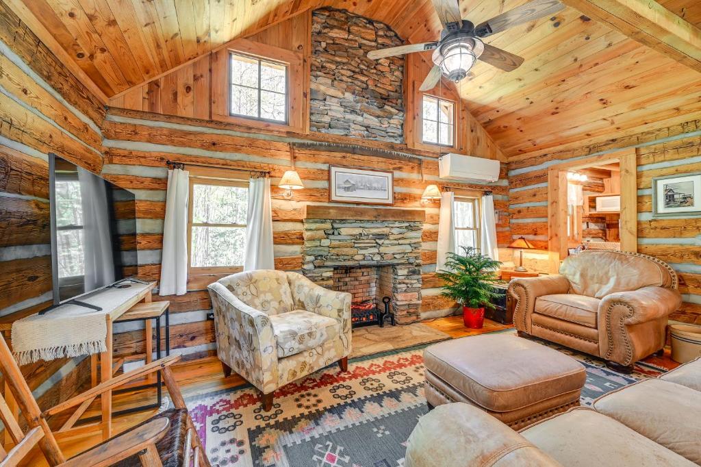 a log cabin living room with furniture and a fireplace at Dobson Vacation Rental - Close to Wineries! in Dobson