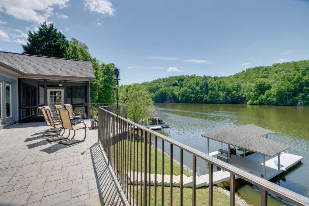 a house with a deck with a view of a river at Waterfront Smith Mountain Lake Home with Boat Dock! in Moneta