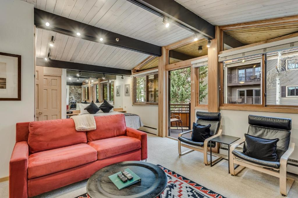 a living room with a red couch and chairs at Laurelwood Condominiums 411 in Snowmass Village