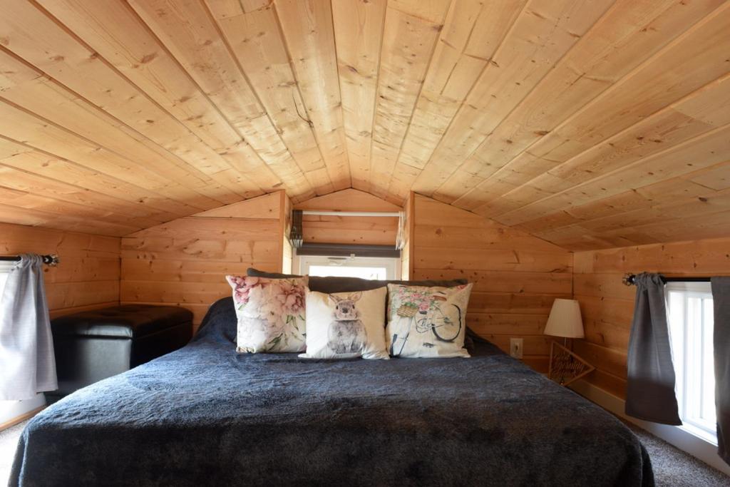 a bed in a room with a wooden ceiling at The Bluebirds Nest in Dufrost
