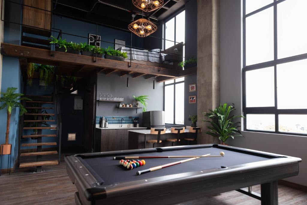 a pool table in a room with a loft at Royal Living in Medellín
