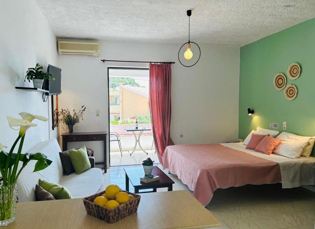 a bedroom with a bed and a living room at Rodakino Βay in Rodakino