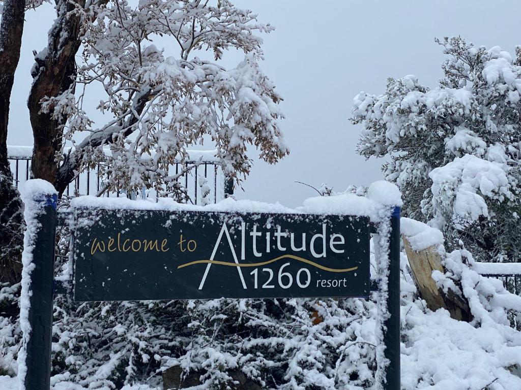 a sign for an entrance to an office in the snow at Altitude 1260 in Jindabyne
