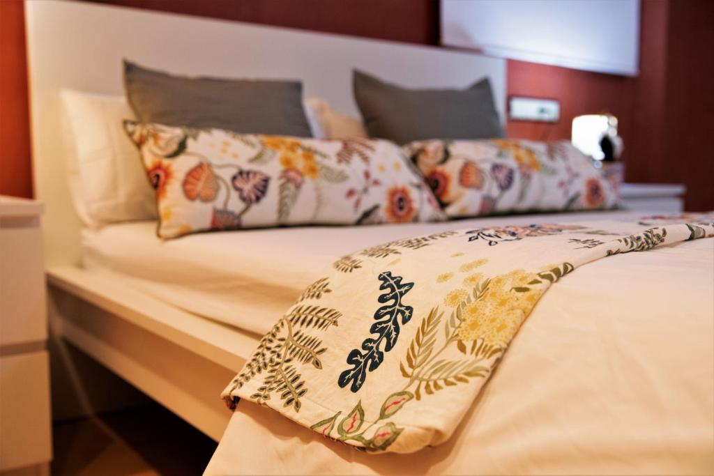 Una cama con almohadas y una manta. en Penthouse Duplex in a 5 floors typical spanish house-8 min to Center by Metro, en Valencia