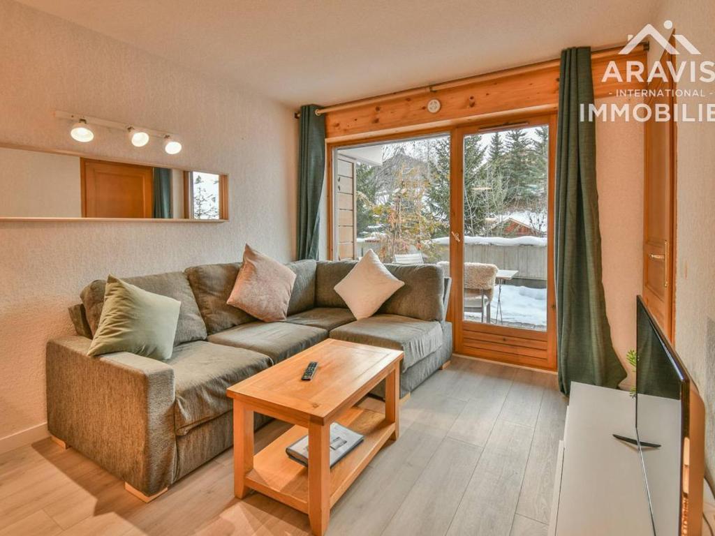 ein Wohnzimmer mit einem Sofa und einem Tisch in der Unterkunft Appartement Le Grand-Bornand, 2 pièces, 4 personnes - FR-1-391-95 in Le Grand-Bornand