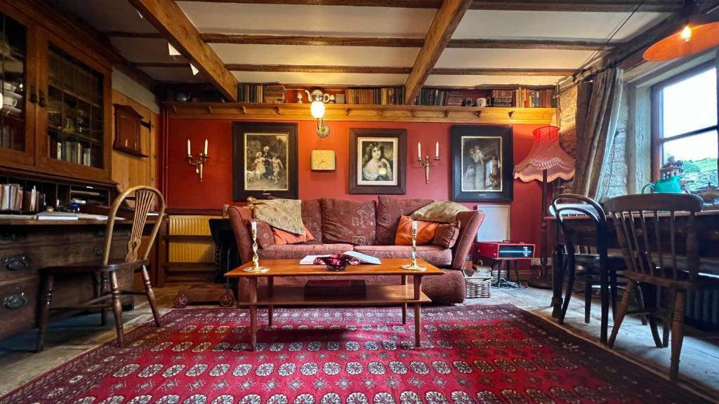 sala de estar con sofá y mesa en The Writers Cottage - Intriguing & Romantic, en Holmfirth