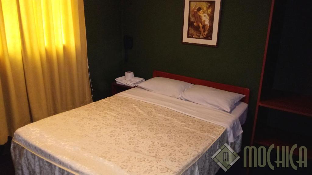 Postel nebo postele na pokoji v ubytování Hostal Residencial Mochica