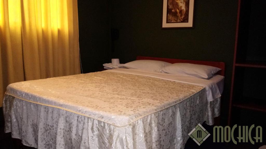 Postel nebo postele na pokoji v ubytování Hostal Residencial Mochica
