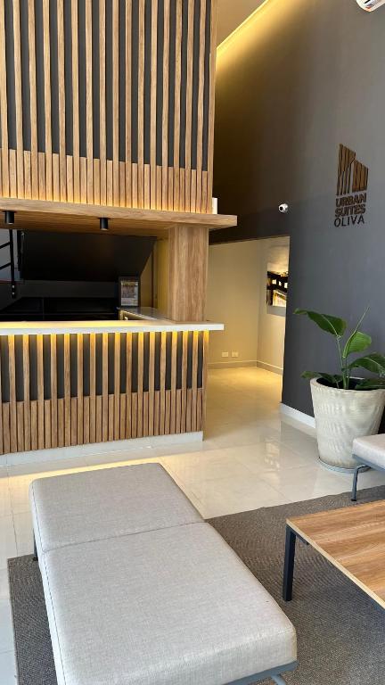 a living room with a bench and a table at Urban Suites Oliva in Oliva