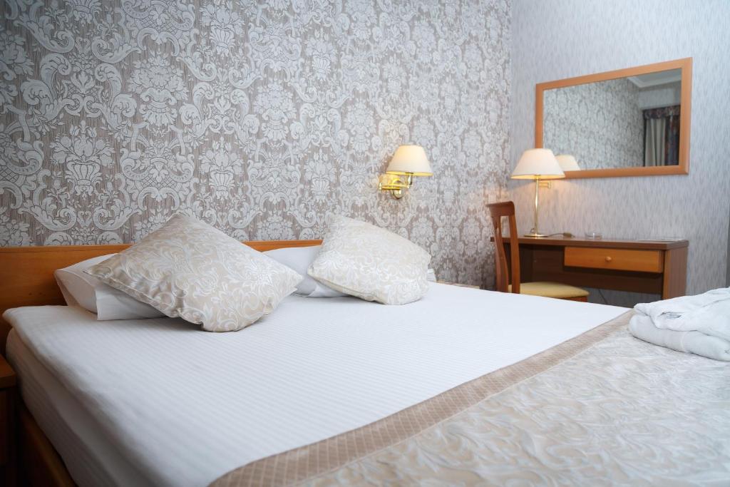 Postel nebo postele na pokoji v ubytování Astana International Hotel