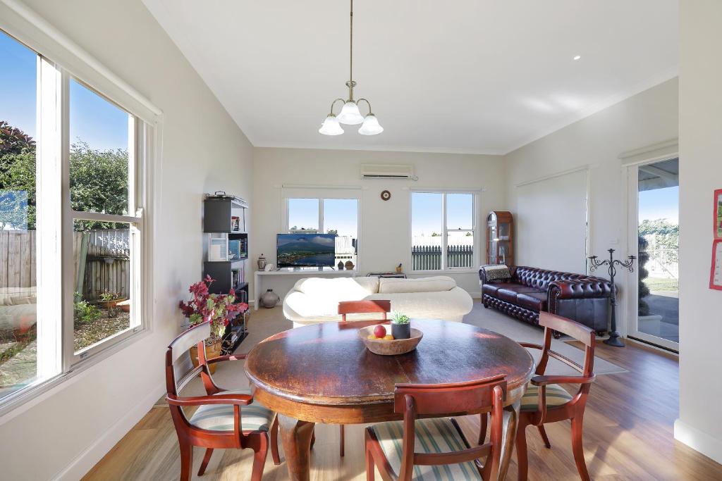a living room with a table and chairs at HiderWay - Perched overlooking Warrnambool's landmarks in Warrnambool