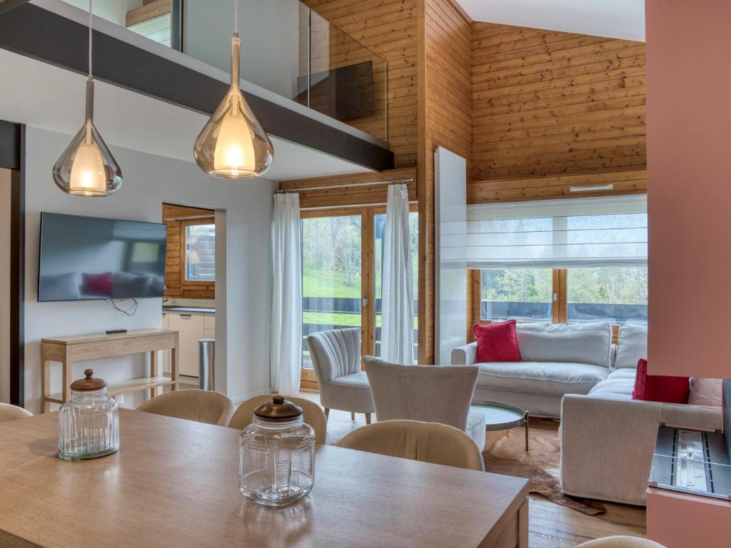 un salon avec une table et des chaises dans l'établissement Appartement 4 Chambres à Megève Mont d'Arbois, Proche Pistes et Golf, 120m², Terrasse, Wi-Fi, Parking - FR-1-453-241, à Megève