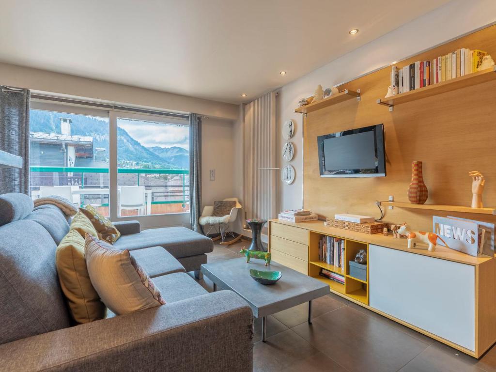 un salon avec un canapé et une télévision dans l'établissement Charmant 3 pièces en plein centre de Megève avec terrasse, 2 chambres et toutes commodités - FR-1-453-268, à Megève