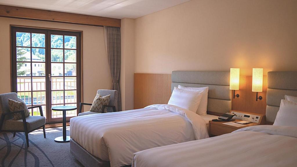Postel nebo postele na pokoji v ubytování Lotte Arai Resort