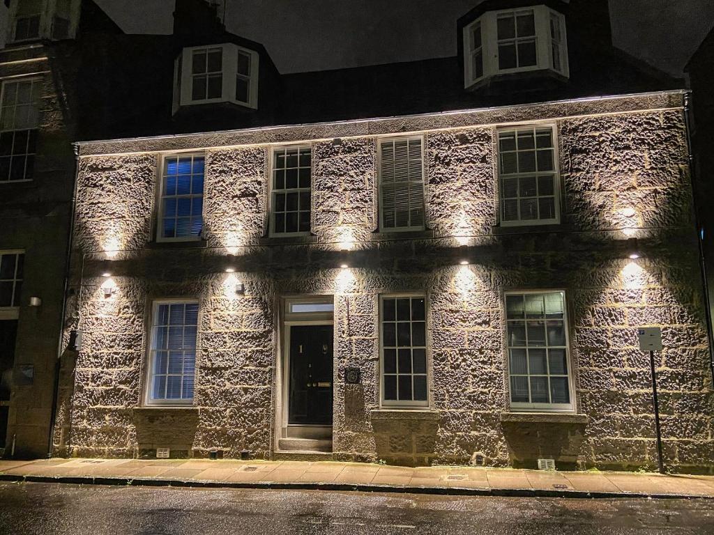a stone building with lights on the side of it at Spire View in Aberdeen