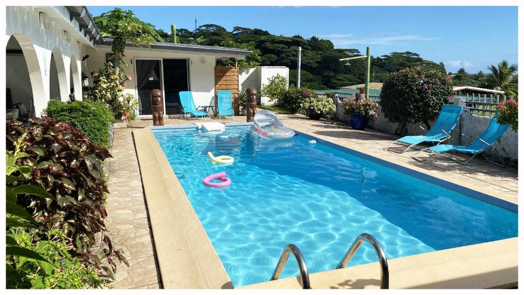a swimming pool with a slide in a house at Mahina's Lodge in Mahina