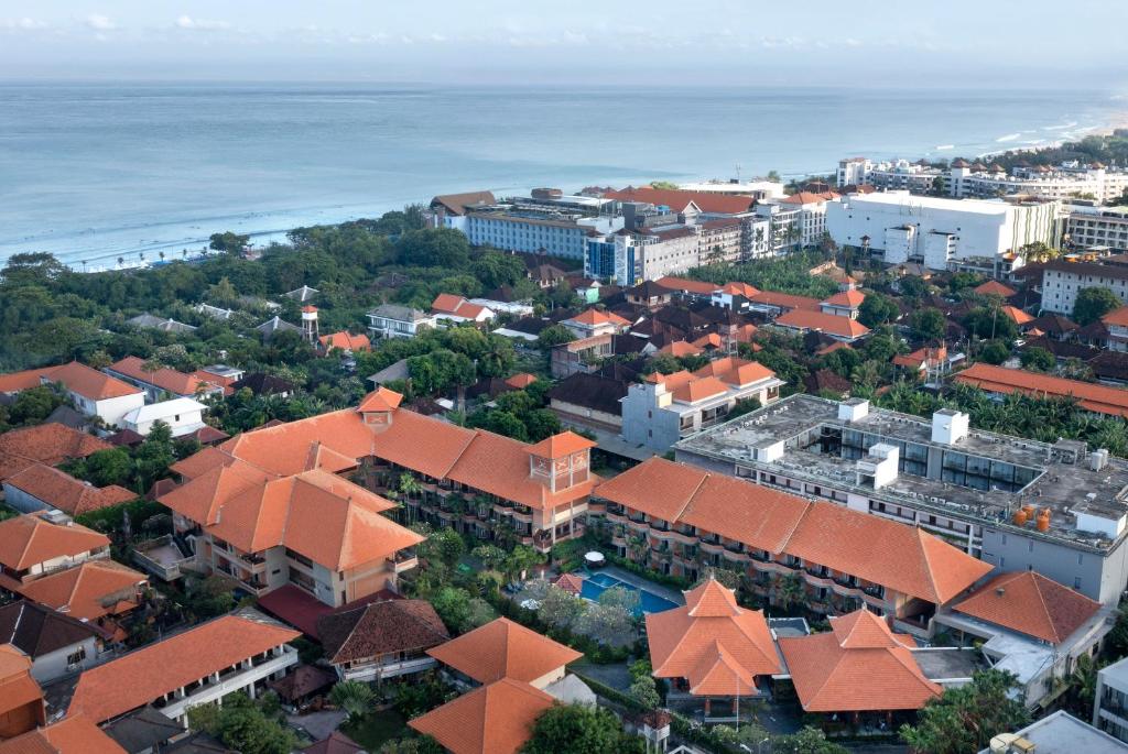 an aerial view of a city with the ocean at Adi Dharma Hotel Kuta in Kuta