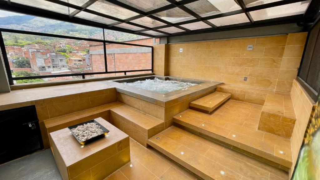 a hot tub in a room with a window at Edificio Helena in Medellín