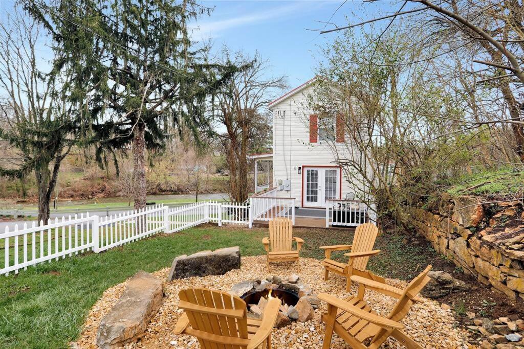 a yard with chairs and a fire pit in front of a house at Hawksbill Home~Hot Tub~Dog Friendly~Modern~Water Front Porch in Luray