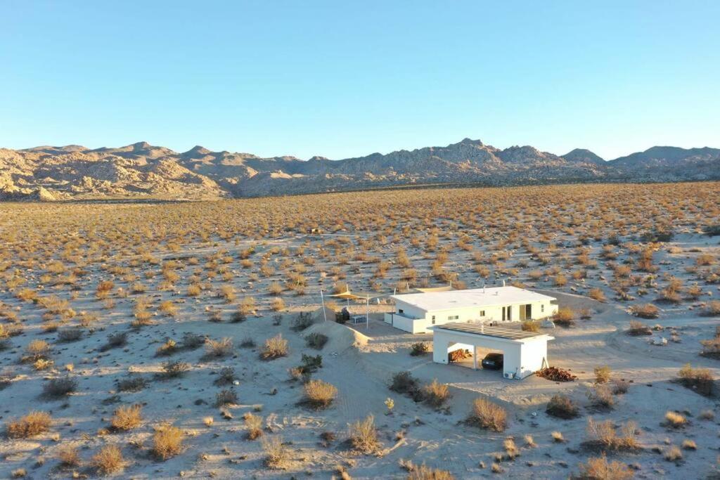 a small white building in the middle of a desert at Blazing Star Estate - 400 feet from JT Park in Joshua Tree