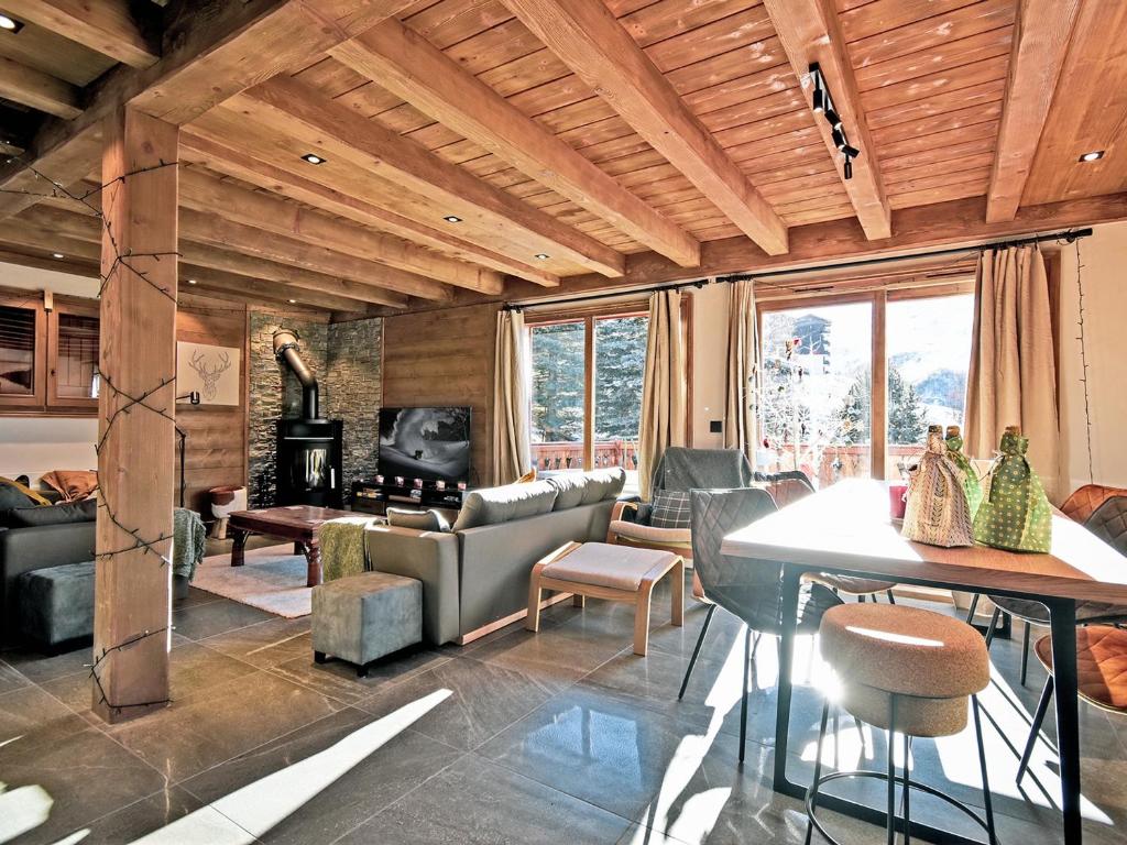 a living room filled with furniture and a fireplace at Chalet Les Menuires, 7 pièces, 10 personnes - FR-1-613B-12 in Levassaix