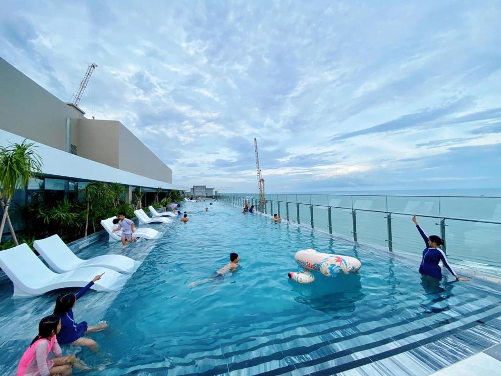 a pool on a cruise ship with people in the water at The Sóng Vũng Tàu - Bin's House in Vung Tau