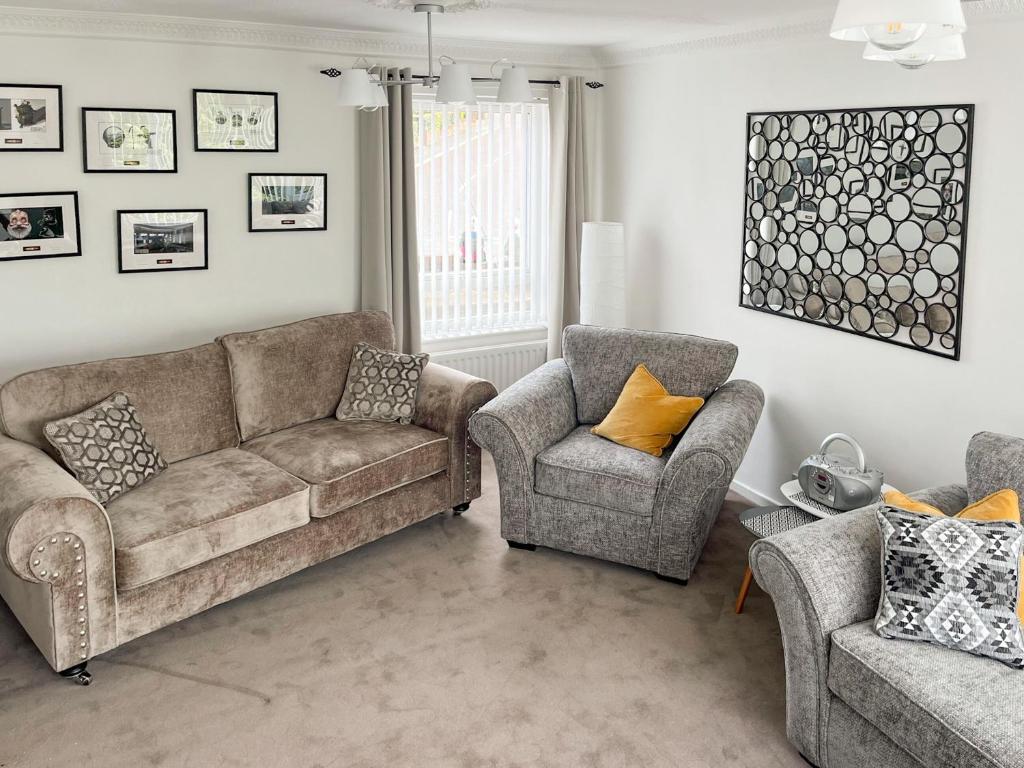 a living room with a couch and two chairs at Burn View in Ryton