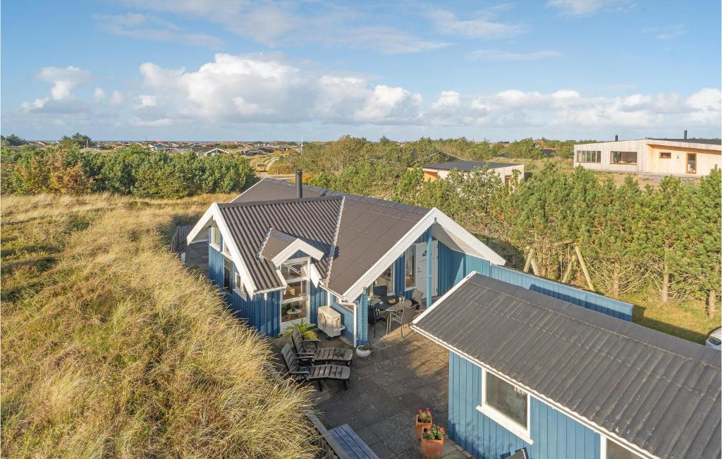 an overhead view of a blue house on the beach at Åbo in Klitmøller