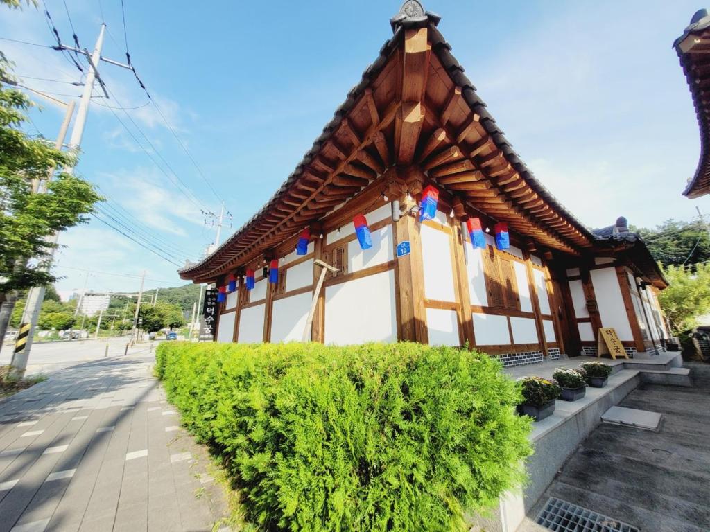 a small building with flags on the side of it at Jeonju Hanok village Deoksugung in Jeonju