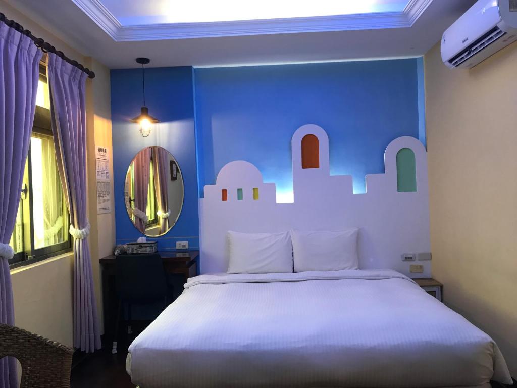 Postel nebo postele na pokoji v ubytování 墾丁貝殼灣旅店