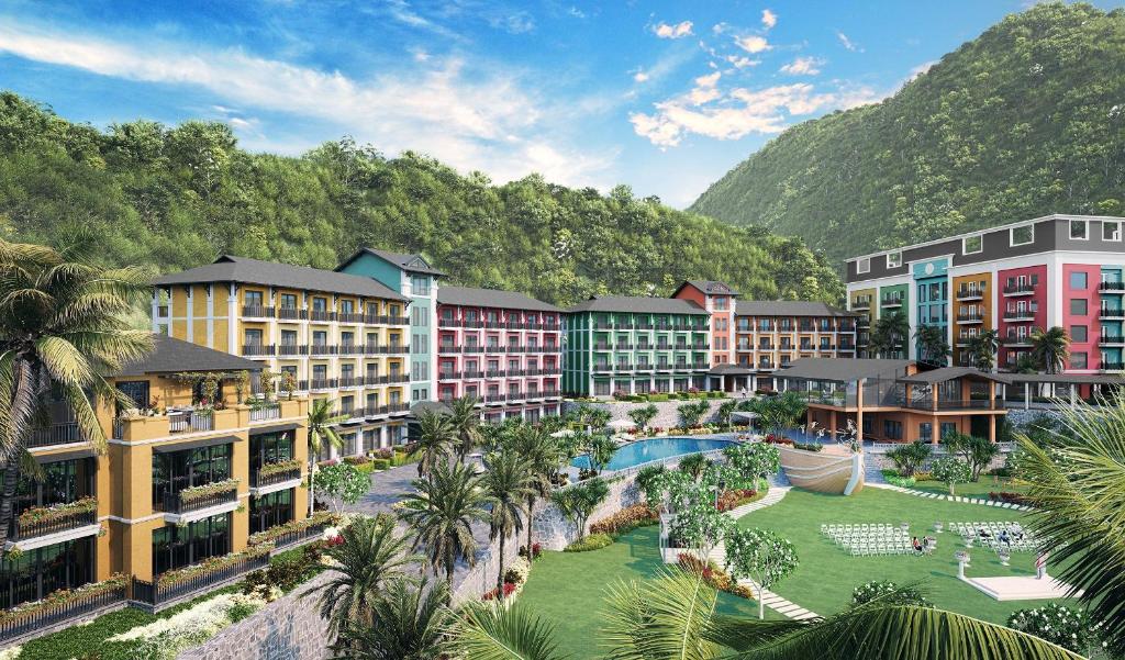 een weergave van een resort met een zwembad en palmbomen bij Cat Ba Island Resort & Spa in Cat Ba
