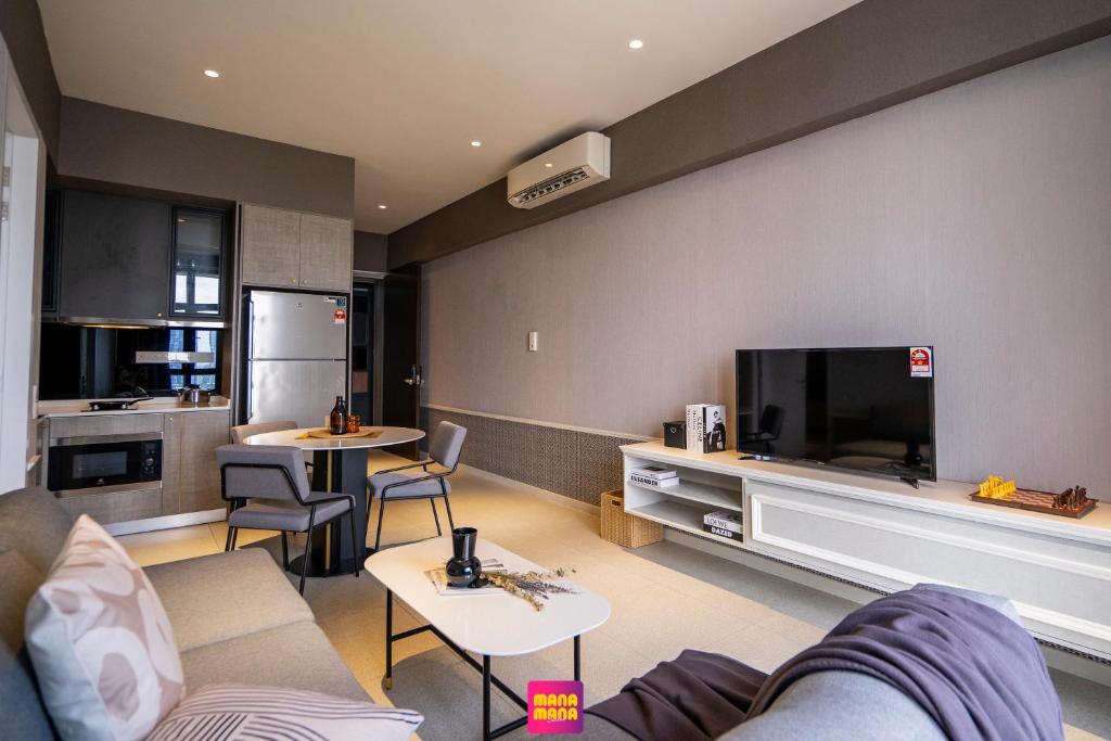a living room with a couch and a flat screen tv at Millerz Square Mana-Mana Suite in Kuala Lumpur