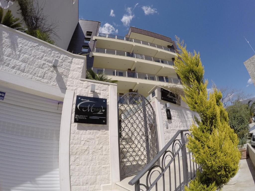 a building with a gate in front of it at Apartments M Palace in Budva