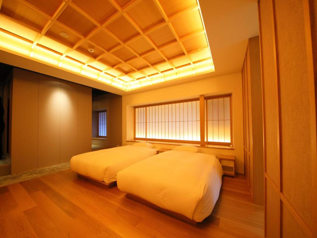 Postel nebo postele na pokoji v ubytování HOTEL VMG RESORT KYOTO