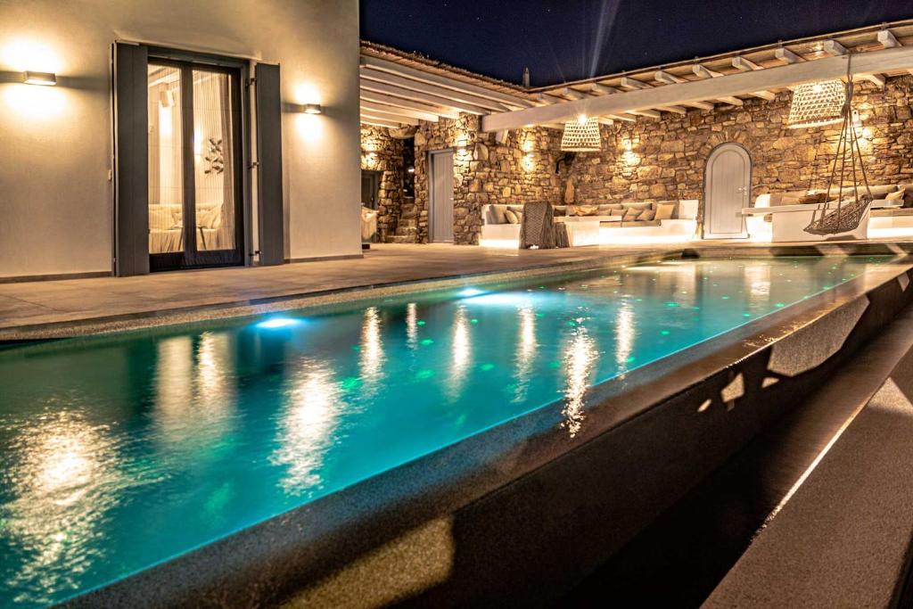 a swimming pool in a house at night at Villa Elia by Mykonian Kazarte in Kalafatis