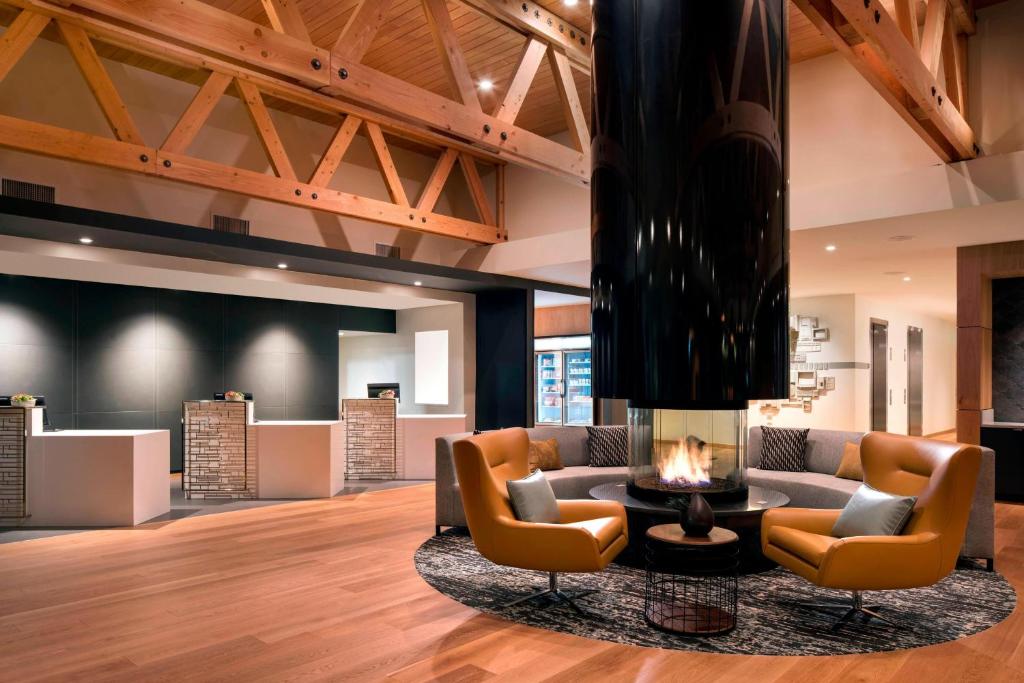 a lobby with a couch and chairs and a fireplace at Residence Inn by Marriott Redwood City San Carlos in San Carlos