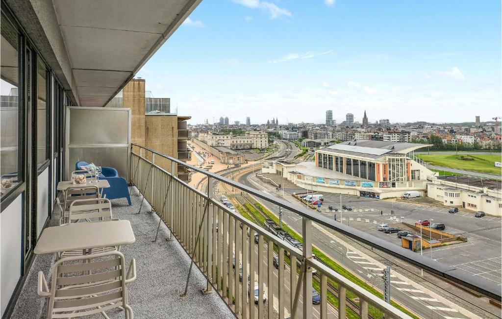 a balcony with chairs and a view of a city at 1 Bedroom Lovely Apartment In Oostende in Ostend