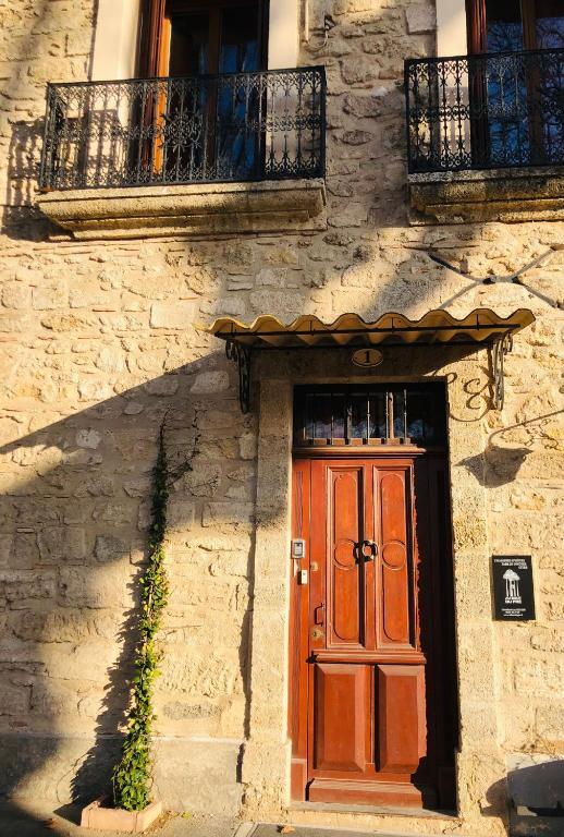 a door on the side of a stone building at Au bout du pré in Pézenas