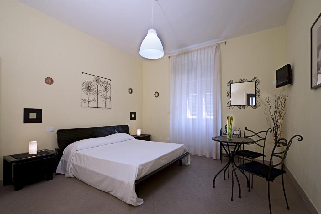 a bedroom with a bed and a table in it at La Casa Di Gabriella in La Spezia