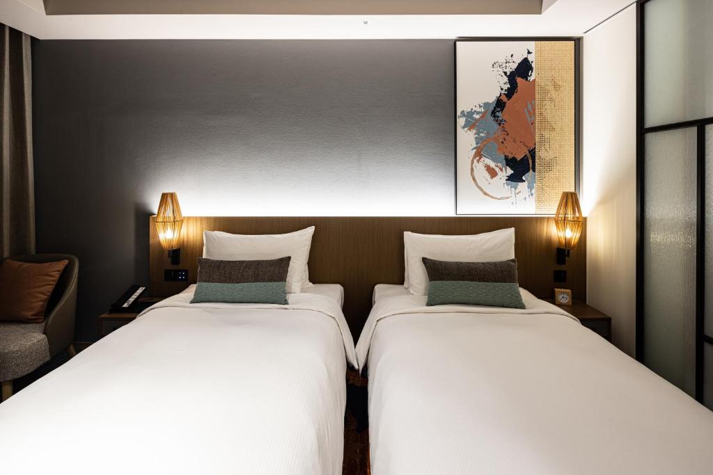 Postel nebo postele na pokoji v ubytování Solaria Nishitetsu Hotel Taipei Ximen