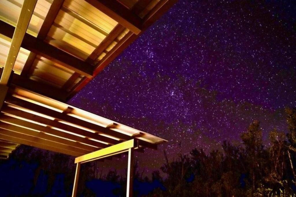 a night view of a starry sky with a house at Volcano Home as seen on the Discovery Channel in Mountain View