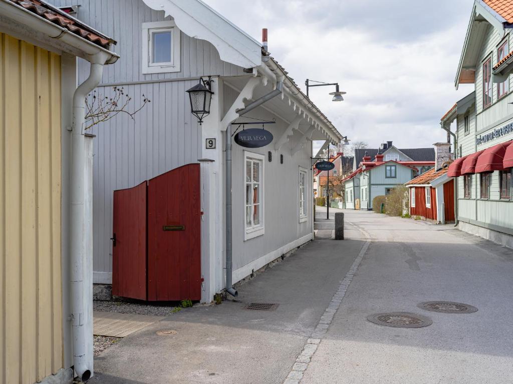 a building with a red door on a street at Villa Vega in Trosa