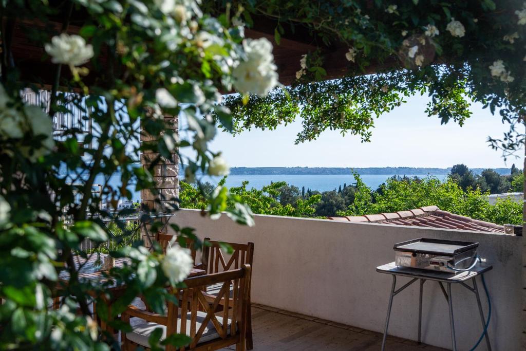 a table and chairs on a balcony with a view of the water at Apartment Černetič in Portorož