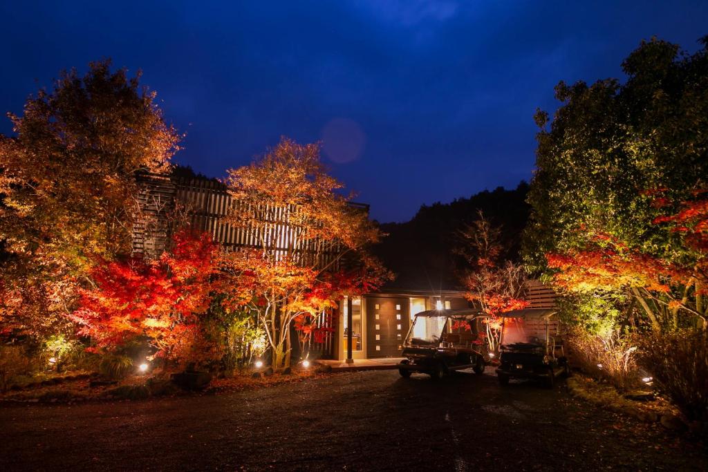 een huis versierd met kerstverlichting 's nachts bij 奥武雄温泉　風の森 in Ureshino